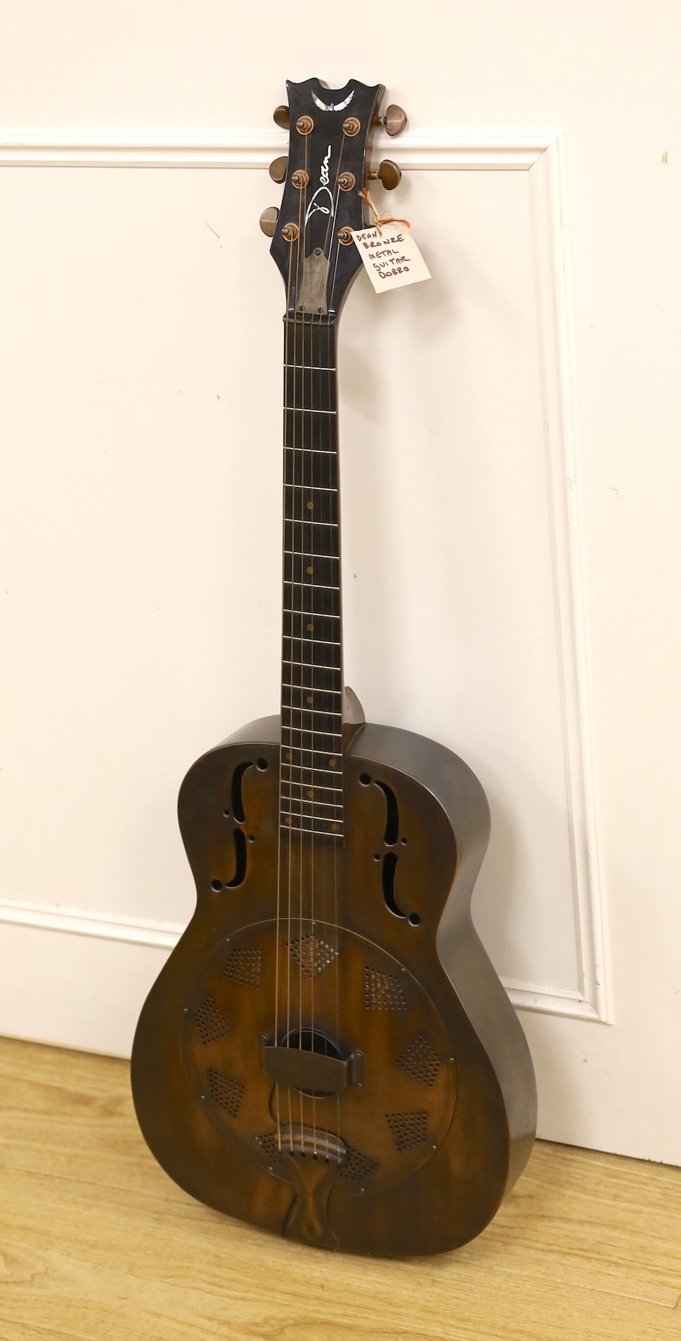 A Dean Resonator Heirloom guitar, bronzed finish, with soft case, 100cms high.